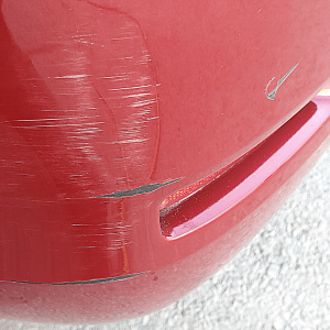Bumper with paint damage and scuffs